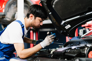 Auto mechanic is diagnosing the cause of an engine problem that needs to be fixed at the shop, Car Service Center and Automobile Maintenance