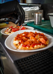 hand of chef baker making mini pita pizza at kitchen. The process of making pita pizza. cooking italian pizza