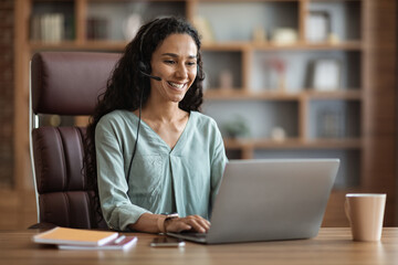 Cheerful brunette woman having online job interview from home