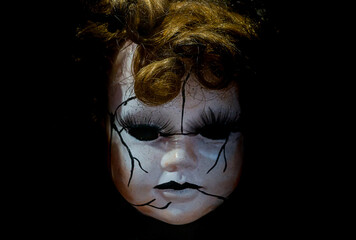 horror style porcelain blonde hair doll face in darkness