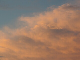 Naklejka na ściany i meble Dramatic sunset with blue sky and orange clouds