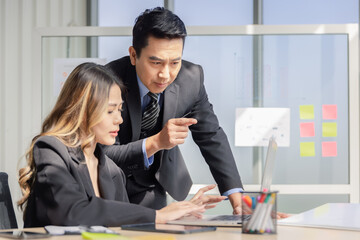 Businessman or manager with formal suit in presentation meeting or mentor with employee or colleague in modern office