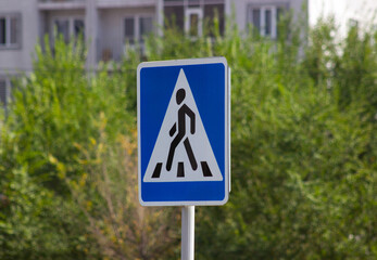 Pedestrian triangle road sign blue background