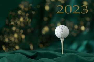 Close-up of golf ball  on green abstract background. New Year card concept