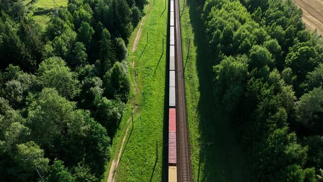 Shipping containers transportation on freight train by railway. Cargo Containers On Railroad. Intermodal Container On Train Car. Rail Freight Shipping Logistics. Multimodal Freight Transportation.