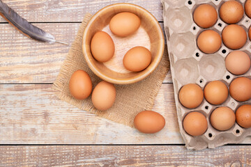 fresh chicken eggs in a wooden bowl Fresh organic eggs from rural farms. put on a wooden table in the room