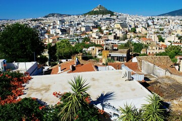 Greece, Athens city view from the area of Anafiotika in Plaka district with Lycabetus hill in the background.
