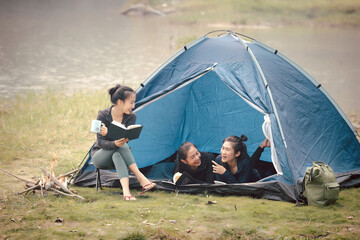 Group of Asian pretty woman camping by the tent. Outdoor activity, adventure travel, holiday vacation concept.