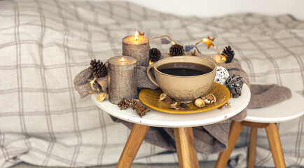 Cozy autumn composition with a cup of tea and decorative details.