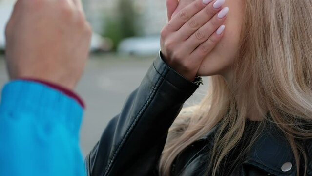 Woman cover her nose because of smoke from an electronic cigarette. Man smoking vape pod system and girl suffocates from vapor.
