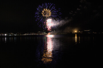 The fireworks paint the sky in various colors and are reflected in the Miseno lake, creating a breathtaking view.