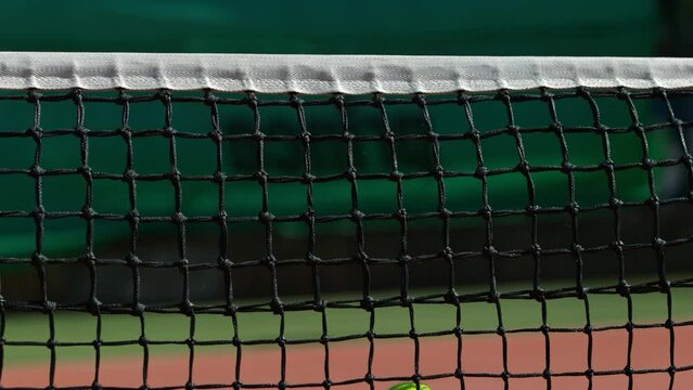 Super Slow Motion Shot of Tennis Ball Hitting the Net on Court at 1000fps.