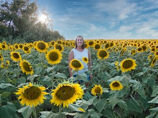 Woman Standing in Large Sunflower Field in Kansas