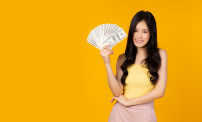 Pretty woman earn a lot of money Asian girl hold dollar, note bank or US money Portrait beautiful...