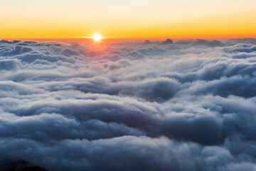 Sunset view of magnificent layered mountains and a sea of clouds in Hehuanshan Forest Recreation Area in Nantou, Taiwan.