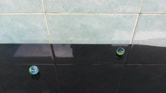 out of focused Glass marble balls playing rolling, n black and blue background, Colorful marbles 