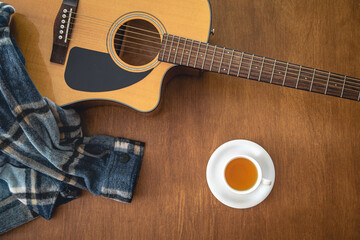 Music background with acoustic guitar, top view.