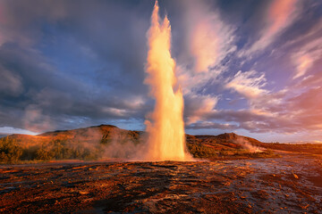 Impressive Eruption of Strokkur Geysir in Iceland during sunset. Strokkur Geyser Is one most...