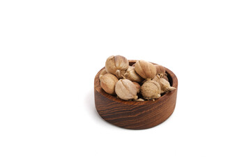 White Cardamom on wooden saucer isolated white background