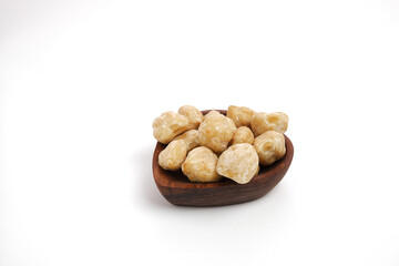 Indonesia Candlenut on wooden with isolated white background