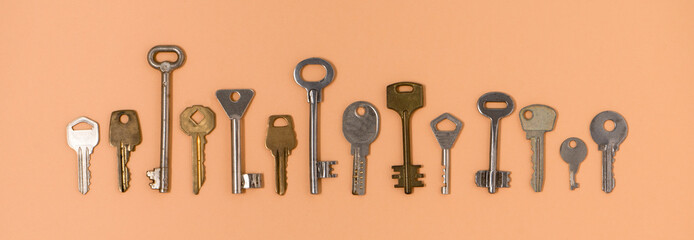 Key Background from different old keys. view from above. Door key in white and yellow metal. Border