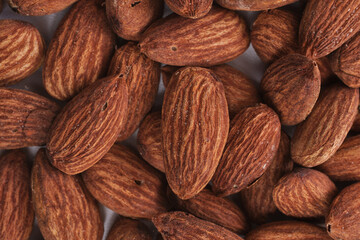 close up of almonds on a white background