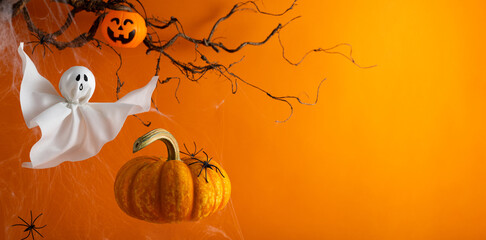 Halloween ghosts with funny pumpkin on orange background. Happy halloween holiday concept. Handmade...