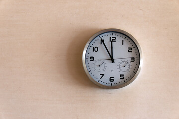 Time flies: clock showing five minutes to twelve