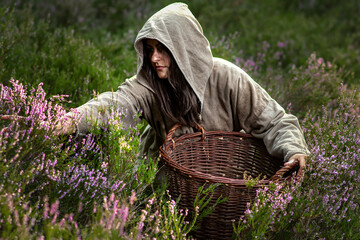 Poor peasant woman in the Middle Ages with a basket