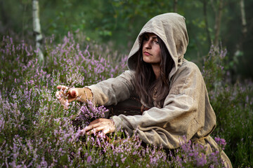 Poor girl is looking for herbs in the bog