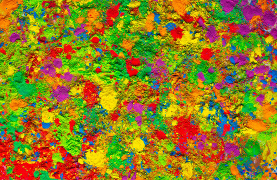 Happy Holi. Colorful background of multicolored gulal powder paints. A colorful festival of colored paints made from powder and dust. Celebration of bright colors of Indian tradition.