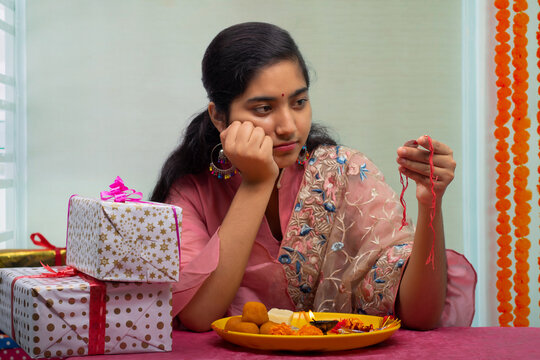 Sister With Pooja Plate And Rakhi Waiting Alone For Her Brother On The Occasion Of Raksha Bandhan