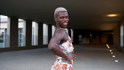 Smiling black transsexual guy in dress looking at camera on street - Powered by Adobe