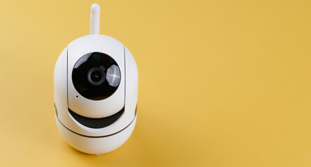 Surveillance camera, videcam, cctv camera isolated on yellow background close up. home security...