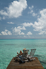 Person relaxing on a deck, Blue Water