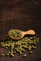 spoon of mung beans on wooden