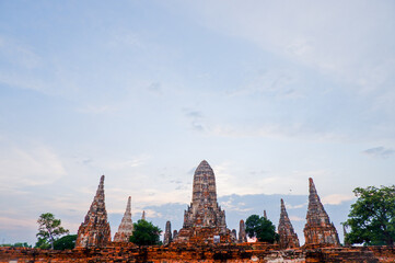 Fototapeta premium Old pagoda and Buddha statue In the evening archaeological site, Phra Nakhon Si Ayutthaya Province, Thailand.