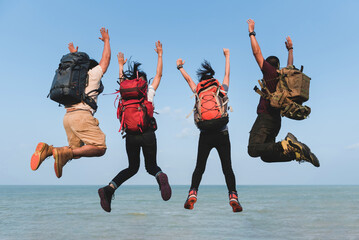 Male and female, Asian, backpacker Hiking and climbing four people , jumping together floating in...