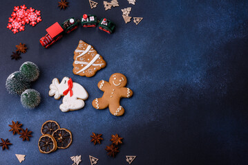 Elements of Christmas decorations, sweets and gingerbread on a wooden cutting board
