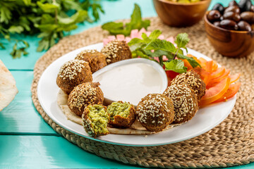 Falafel Plate with dip served in dish isolated on wooden table side view of middle eastern food