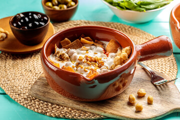 Fattet Hummus with chick peas served in dish isolated on wooden table side view of middle eastern food