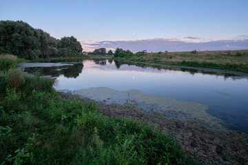 Fototapeta na wymiar Quiet evening over a rural lake