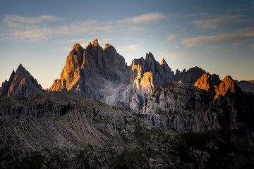 Fototapeta na wymiar The mountains of the Cadini Group at sunrise at the Drei Zinnen Hütte in the Dolomites in South Tyrol, Italy.