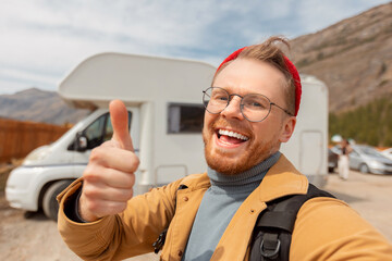 Young man hipster traveler making selfie background camper car. Concept vanlife adventure, vacation