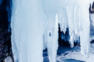 Blue ice cave grotto lake Baikal Olkhon island, Russia. Frozen clear icicles, beautiful winter...