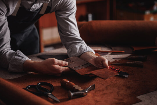 Handicraft production, Craft man tailor checks handmade brown leather product