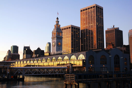 An early morning sunrise light begins to glow on the Port of San Francisco, the Ferry building and the city skyline