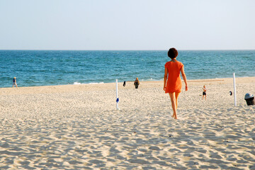 An adult woman finds solitude waling on the sand of East Hampton's Main Beach, in the Hamptons, on...