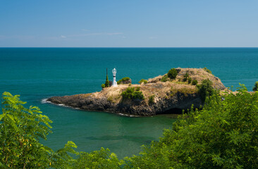 Fototapeta na wymiar Small lighthouse on the beach.