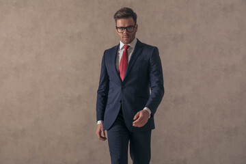 portrait of handsome businessman wearing elegant suit and glasses